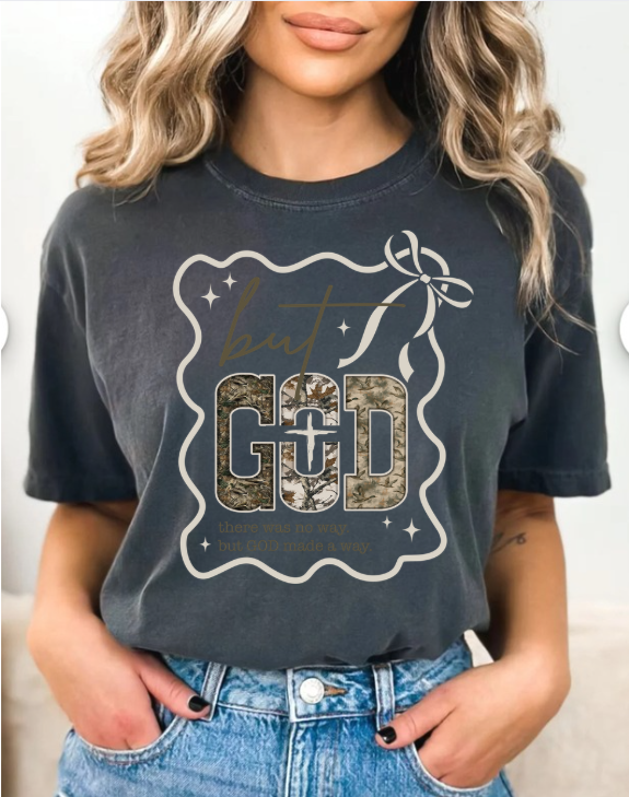 Person wearing a dark gray t-shirt with a graphic design and text that says But God there was no way but god made a way