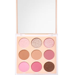 Makeup palette with various shades of pink, gold, and brown on a white background