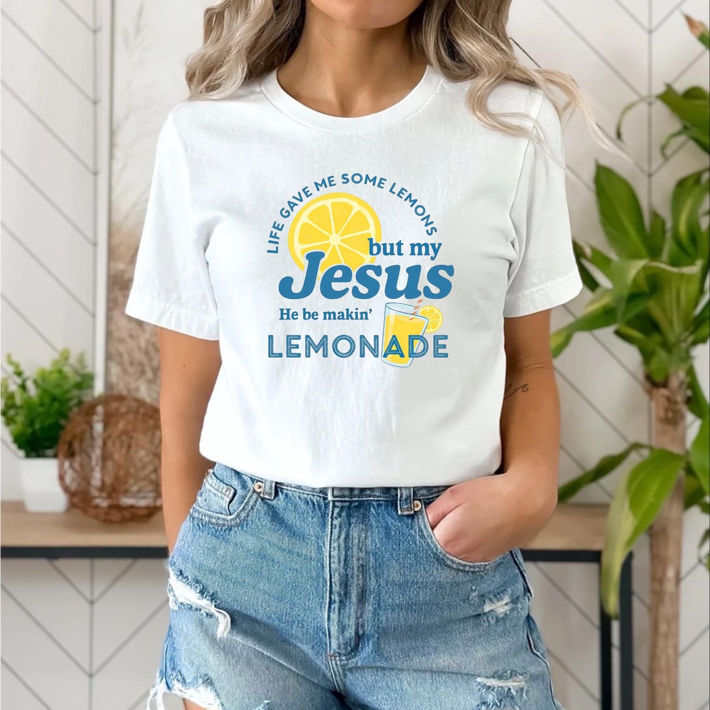 Person wearing a white t-shirt with a lemon-themed graphic and text.