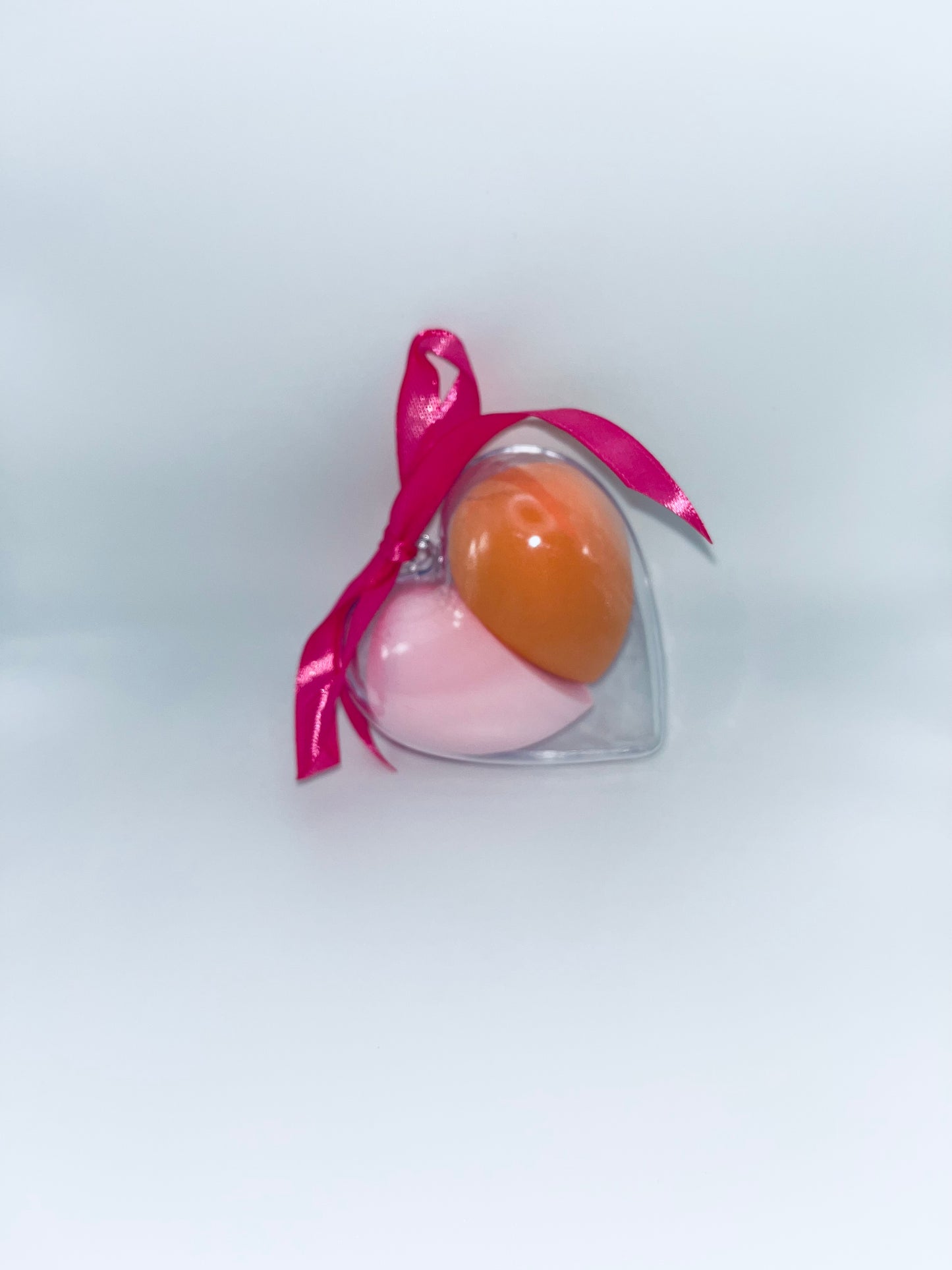 Heart-shaped container with pink and orange colors on a white background