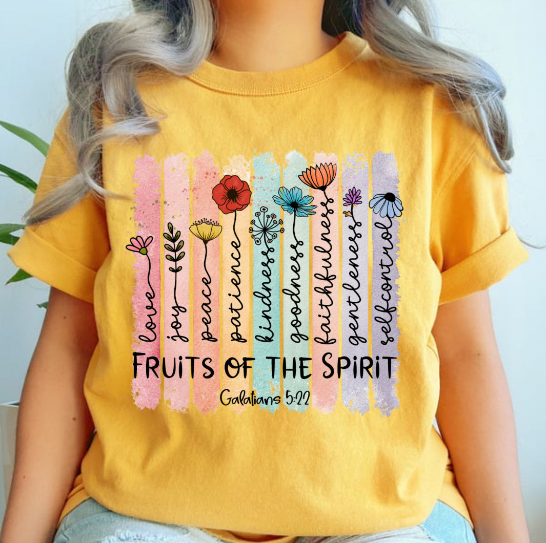 Person wearing a yellow t-shirt with 'Fruits of the Spirit' design and text.