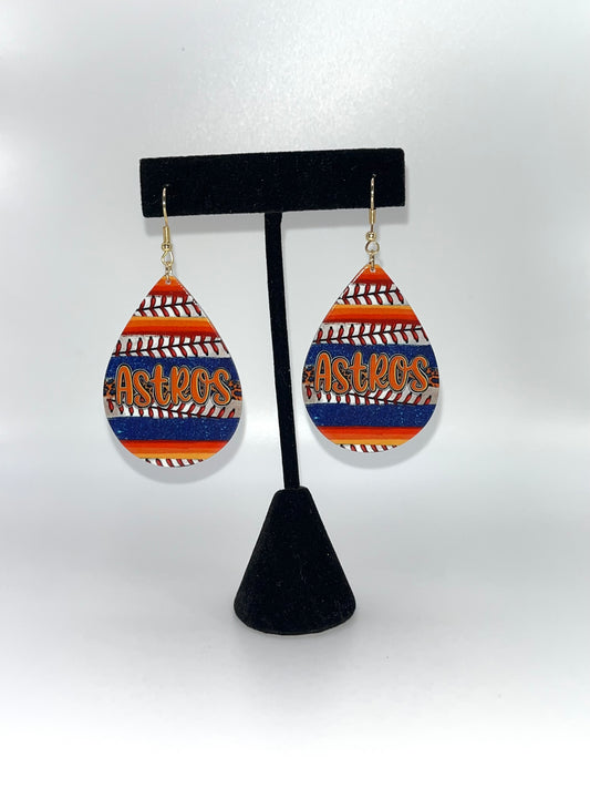 Teardrop-shaped earrings with 'Astros' text on a black stand against a white background