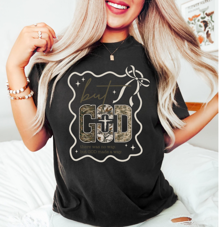 Person wearing a black t-shirt with a graphic design and text that says But God there was no way but god made a way 
