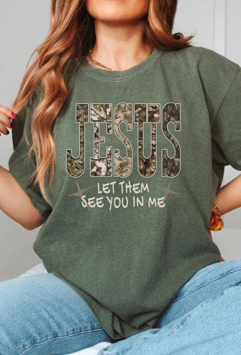 Person wearing a green t-shirt with a graphic design and text.