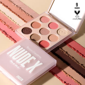 Makeup palette with 'Nude' text on a pink case, surrounded by makeup products.